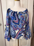 On or off-the-shoulder top smocked elastic neckline and flared bell sleeves.