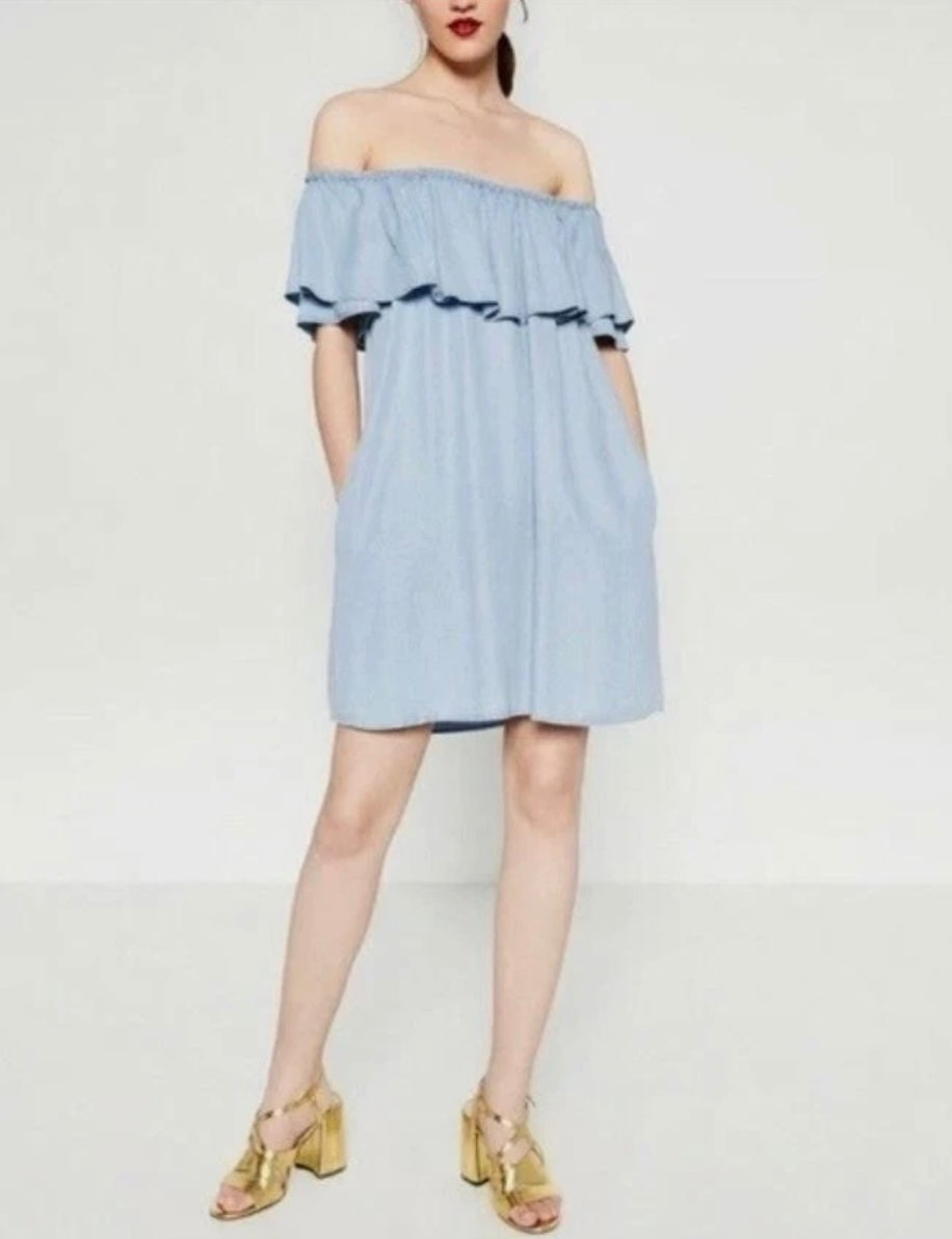 Denim dress in light wash chambray fabric and a ruffled off-the-shoulder neckline (30-day rental)