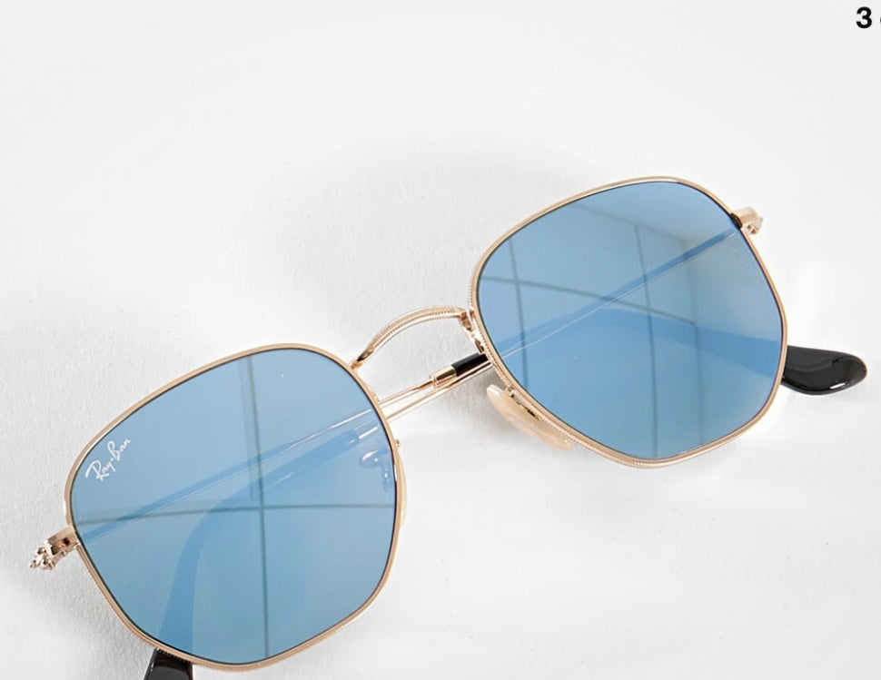Ray-Ban Hexagonal sunglasses featuring a thin gold metal frame and striking blue mirror lenses (30-day rental)