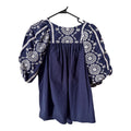Navy Crown & Ivy blouse features intricate white embroidery on the puff sleeves and neckline (30-day rental)