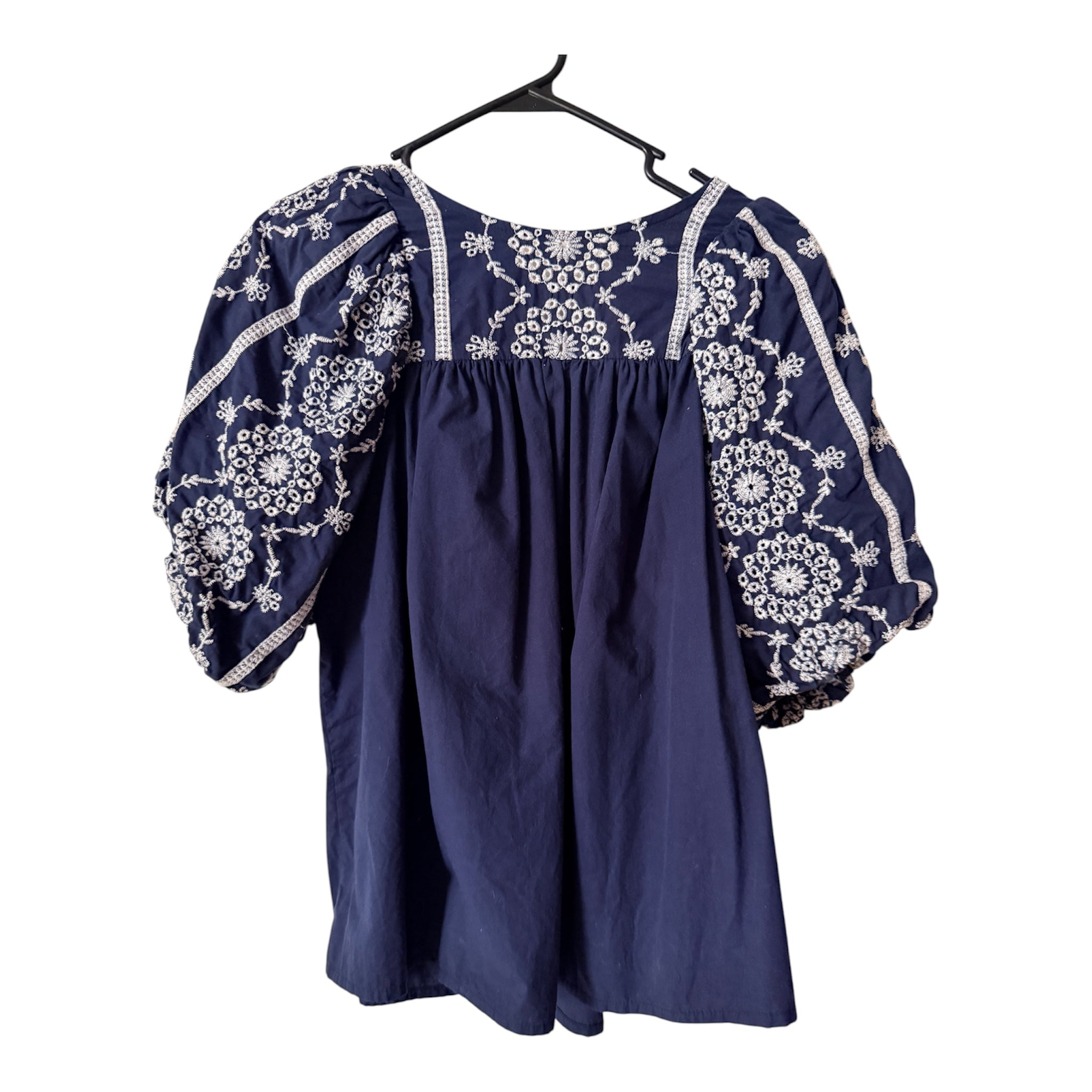 Navy Crown & Ivy blouse features intricate white embroidery on the puff sleeves and neckline (30-day rental)