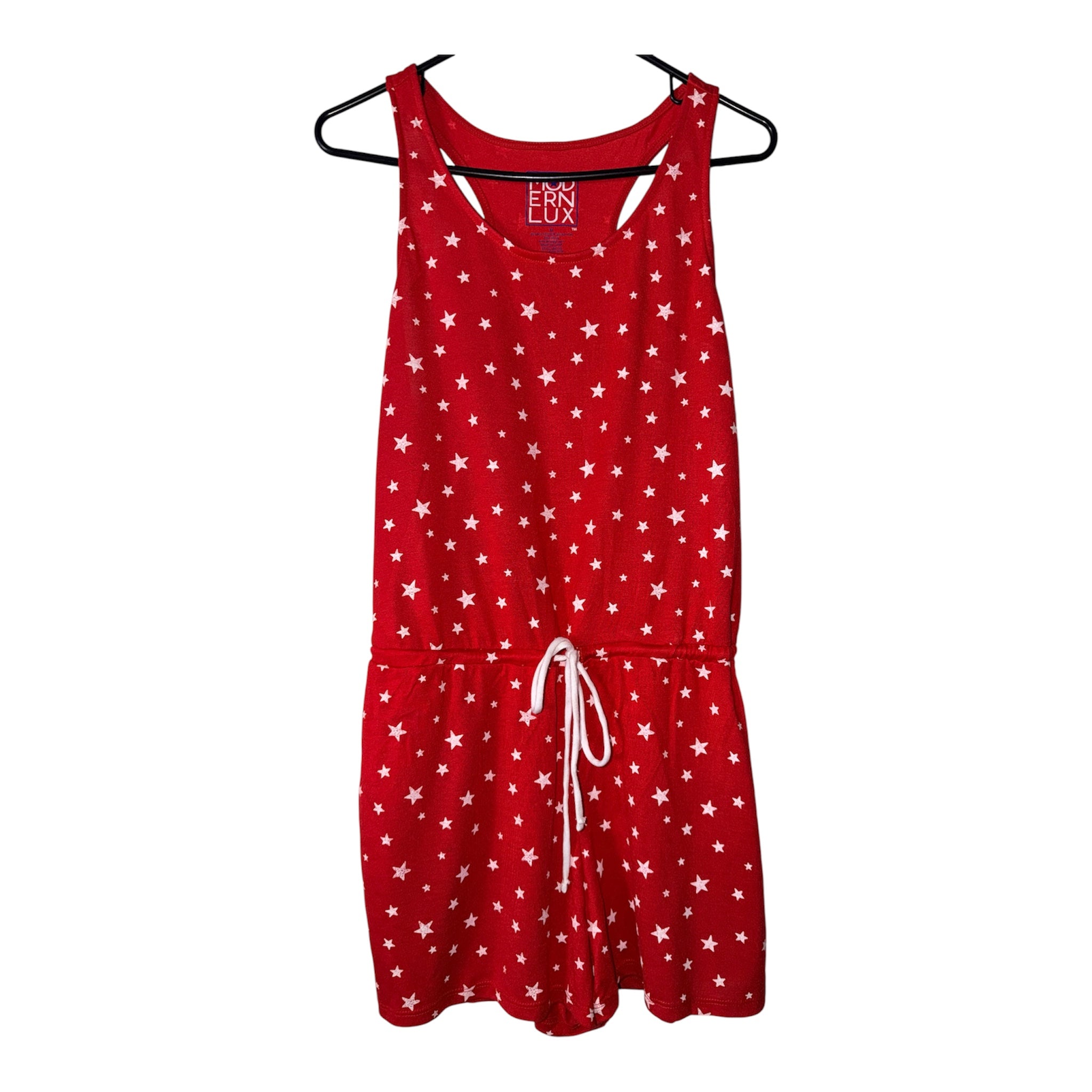 Modern Lux sleeveless romper features an all-over white star print and a drawstring tie waist (30-day rental)