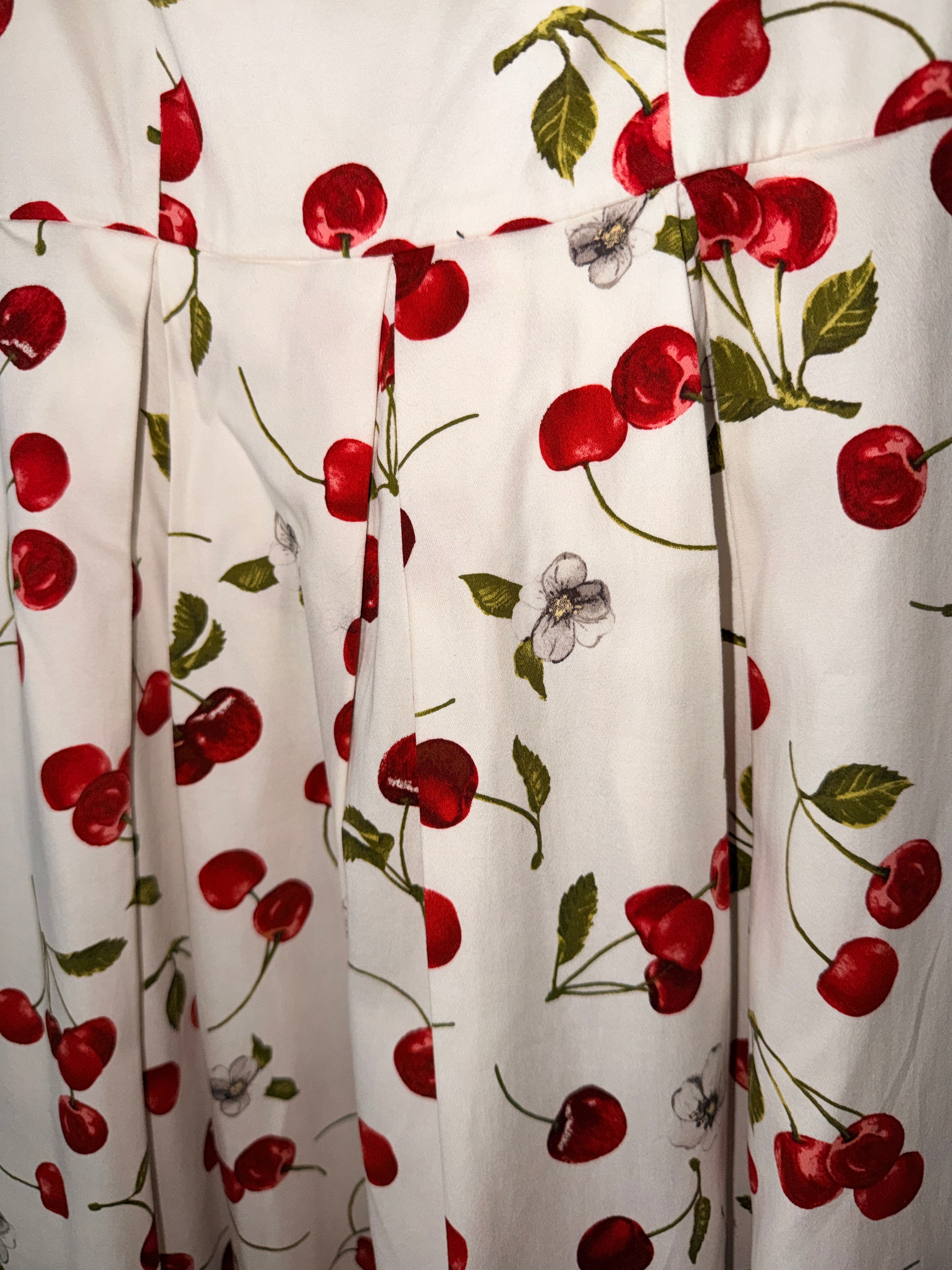 Leslie Fay retro-style dress features a vibrant red cherry print (30-day rental)