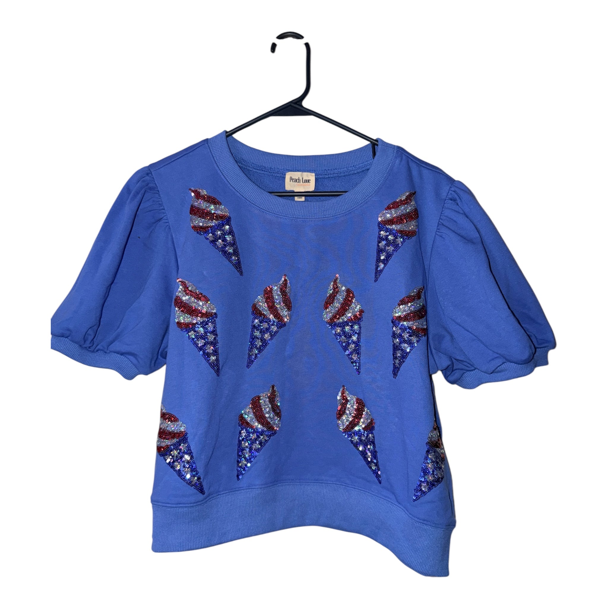 short-sleeve, crewneck sweatshirt sequined ice cream cones styled with the American flag's stars and stripes.