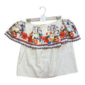 White off-the-shoulder top featuring a geometric patterned ruffle border