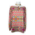 long-sleeve blouse features a bold geometric and paisley print with a boat neckline.
